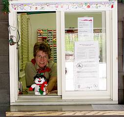 Sherry at service window decorated for Christmas in August